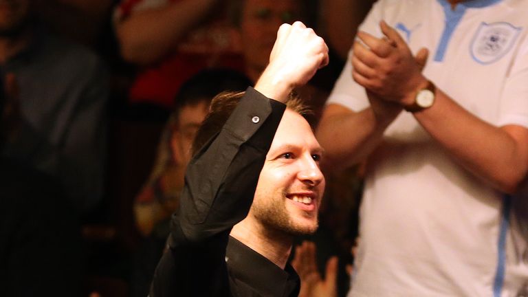 Judd Trump celebrates victory over Liang Wenbo