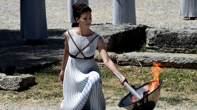 Greek actress Katerina Lechou, acting as the high priestess, lights the Olympic flame at the Temple of Hera 