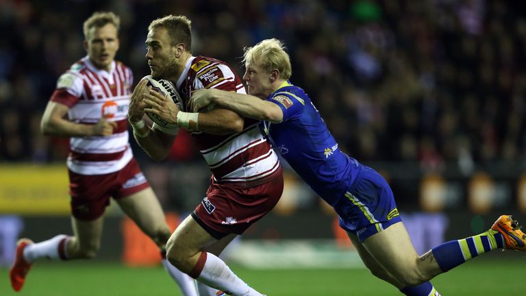 Lee Mossop is tackled by Rhys Evans at the DW Stadium