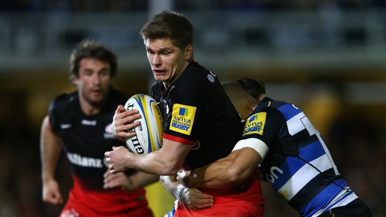 Owen Farrell of Saracens is tackled by Jonathan Joseph of Bath 