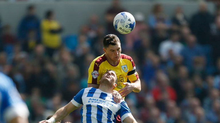 Burnley's Michael Keane and Brighton's Tomer Hemed battle for the ball