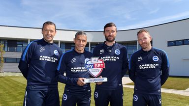 Image of Chris Hughton celebrates his Sky Bet Championship Manager of the Month award with his staff