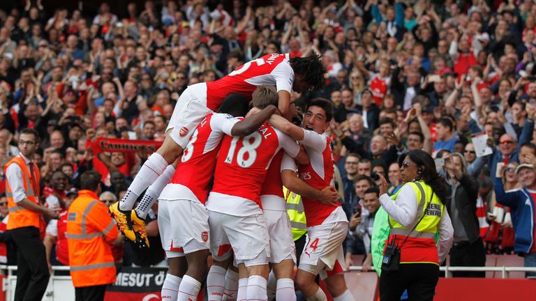 Arsenal players mob Mikel Arteta after the fourth goal