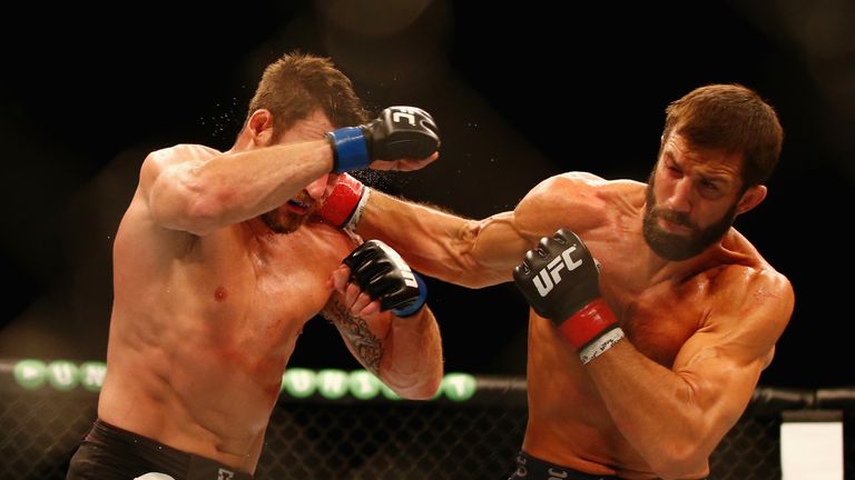 Luke Rockhold (right) lands a punch on Michael Bisping