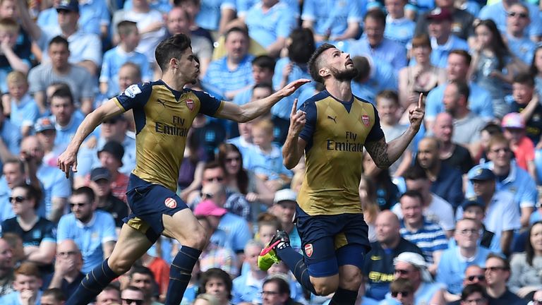 Olivier Giroud (right) celebrates after scoring at the Etihad