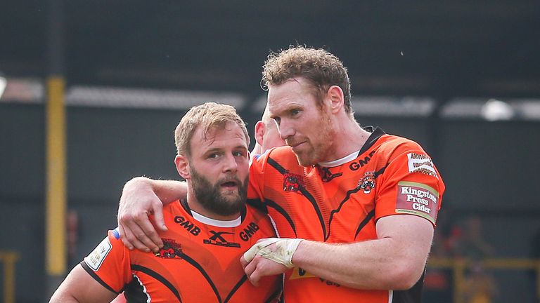 Castleford's star man Paul McShane (left) is congratulated on his try by Joel Monaghan (right)