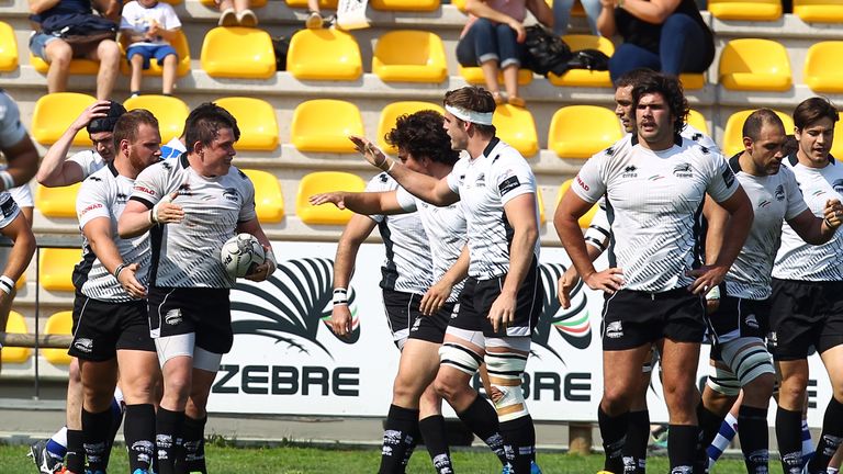 Zebre's Andrea Lovotti (with ball) celebrates his try against the Dragons