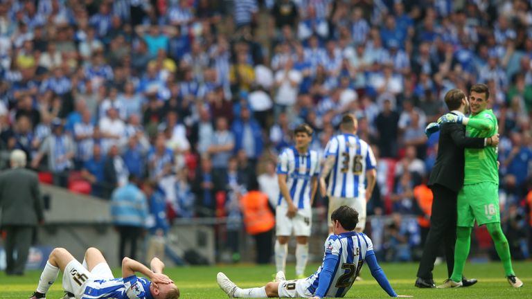 Dejected Sheffield Wednesday players are left on the Wembley pitch