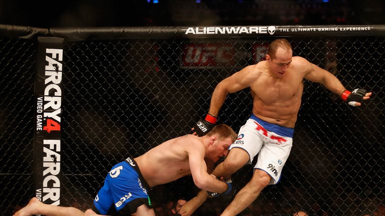 Is this safety-first approach advisable for new champion Miocic (left)?