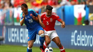 Image of  Robert Mak of Slovakia (left) battles with Wales' Neil Taylor