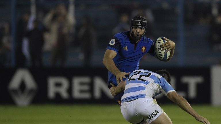 France centre Julien Rey tries to elude a tackle by Argentina centre Santiago Gonzalez