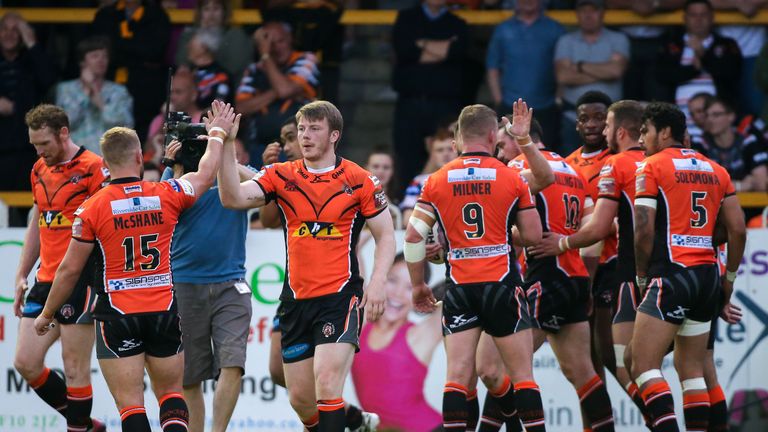 Castleford's Paddy Flynn (third left) is congratulated by Paul McShane (15) on scoring a try