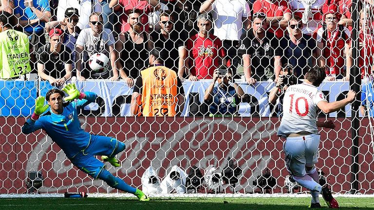 Poland's midfielder Krychowiak (R) scores his penalty against Switzerland