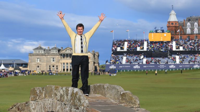 Sir Nick Faldo salutes the crowd on the Swilcan Bridge at St Andrews last year