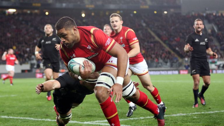 Sam Cane attempts to tackle Wales' Taulupe Faletau as he heads for a try