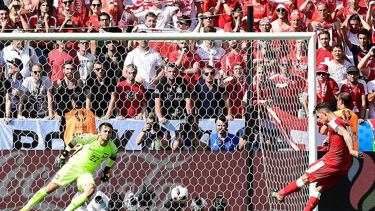 Switzerland's midfielder Granit Xhaka (R) misses his penalty attempt