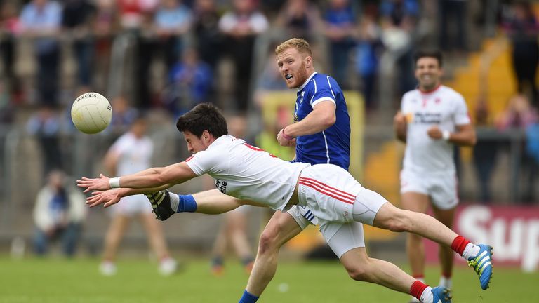 James McEnroe of Cavan is tackled by Mattie Donnelly of Tyrone