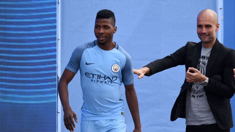 Kelechi Iheanacho is joined by new manager Pepe Guardiola as he models the new Manchester City home kit
