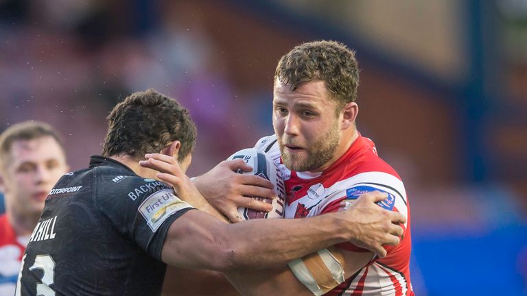Salford's Olsi Krasniqi is tackled by Widnes's Hep Cahill