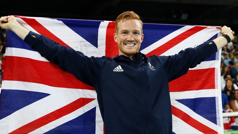 Rutherford proudly displays the Union Jack after his third place in the long jump