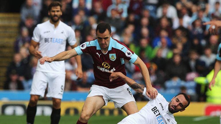 Dean Marney of Burnley battles for possession with Leon Britton of Swansea City