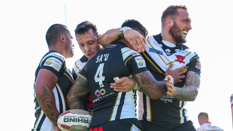 Junior Sa'u is congratulated after scoring against the Bulldogs