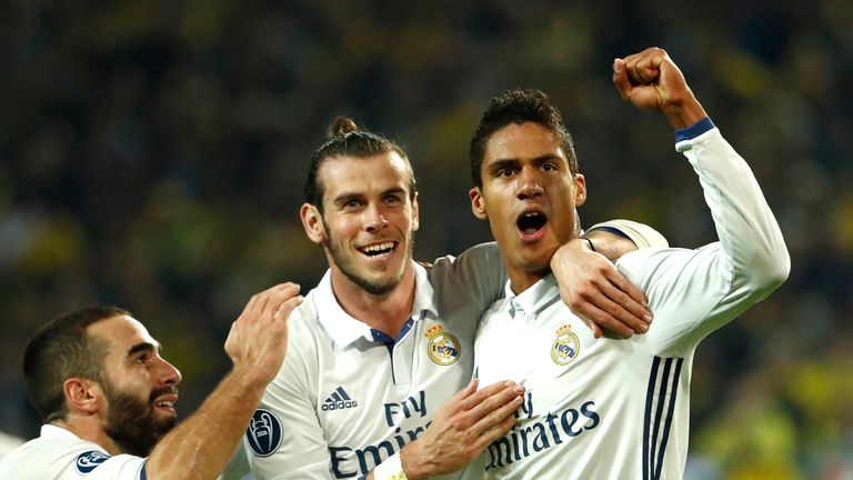 Real defender Raphael Varane (R) celebrates with Gareth Bale after putting Madrid 2-1 ahead at Dortmund
