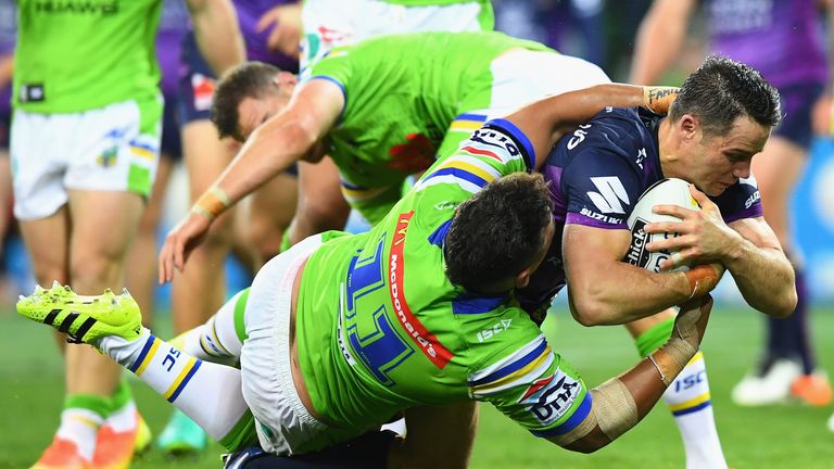 Cooper Cronk breaks the tackle of Josh Papalii to score