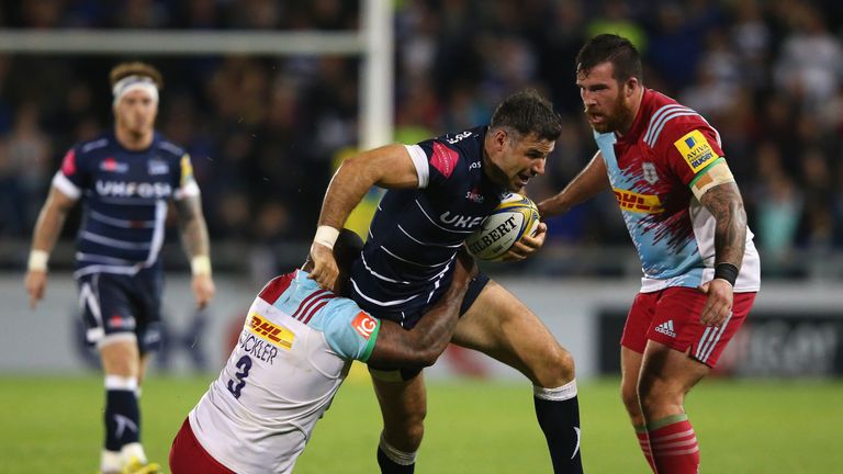 Sale scrum-half Mike Phillips is tackled by Kyle Sinckler