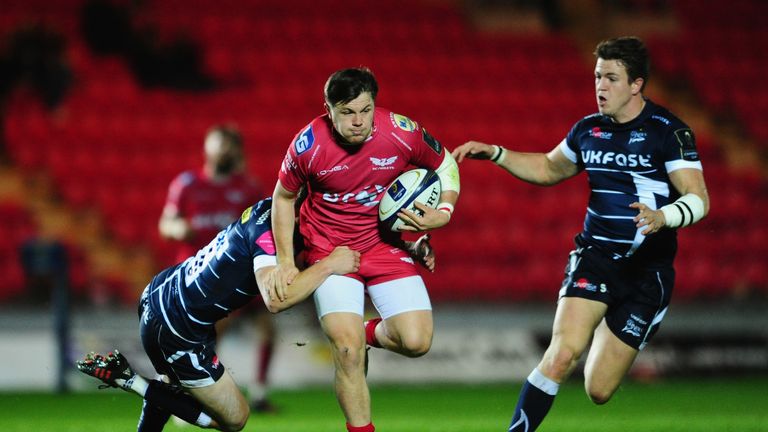 Scarlets' Steffan Evans runs at the Sale defence