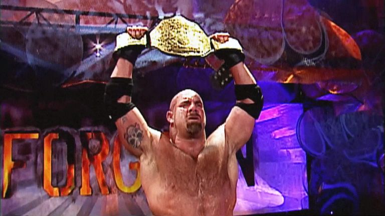 Goldberg holds the World Heavyweight Title aloft at Unforgiven 2003