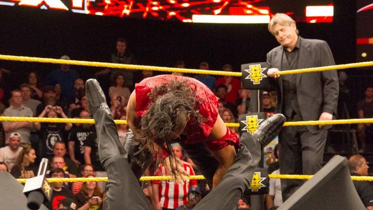Shinsuke Nakamura smashes a security guard through a table