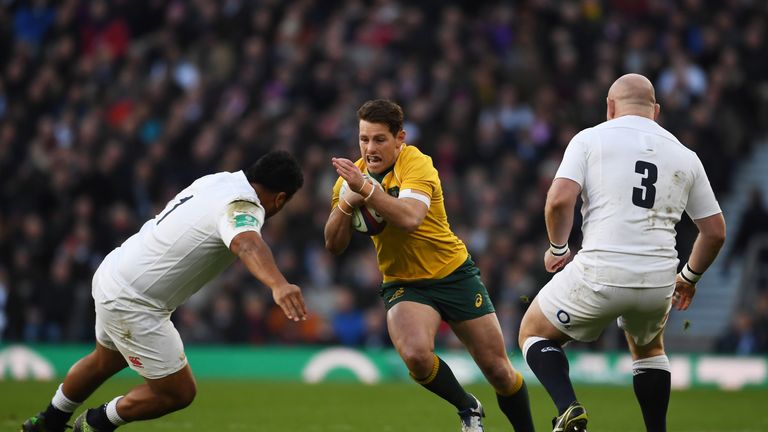Bernard Foley of Australia (C) attempts to take the ball past England props Dan Cole  (R) and Mako Vunipola  (L) 