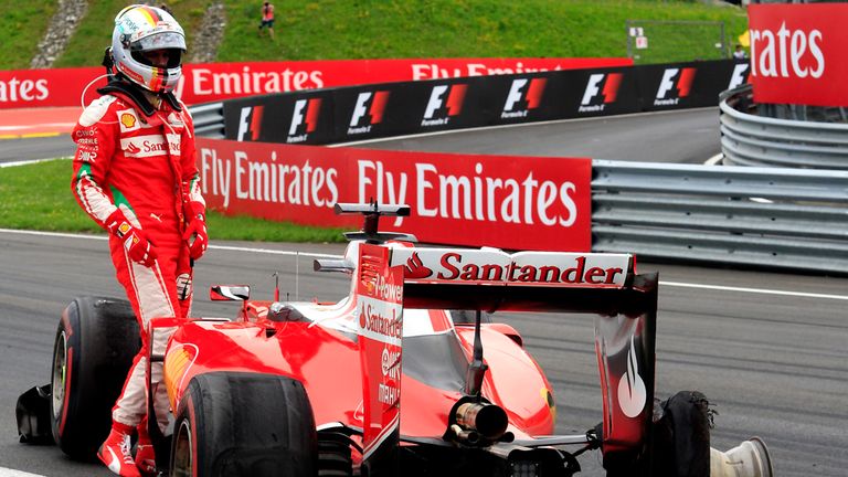 Sebastian Vettel examines his punctured Ferrari car at the Austrian GP - Picture from Sutton Images