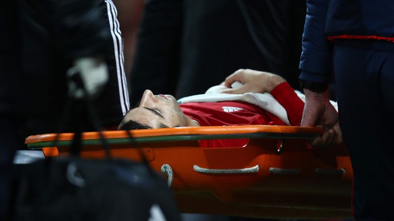 Henrikh Mkhitaryan is stretchered off towards the end of the game