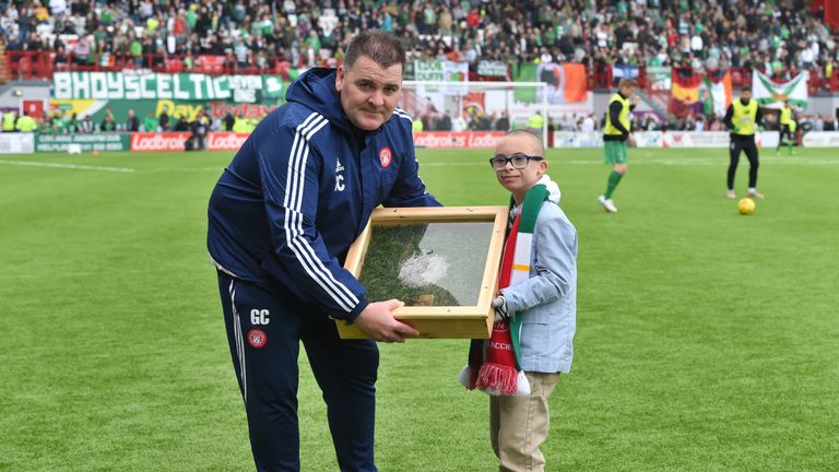 Hamilton coach George Cairns presents Jay Beatty with his goal of the month award