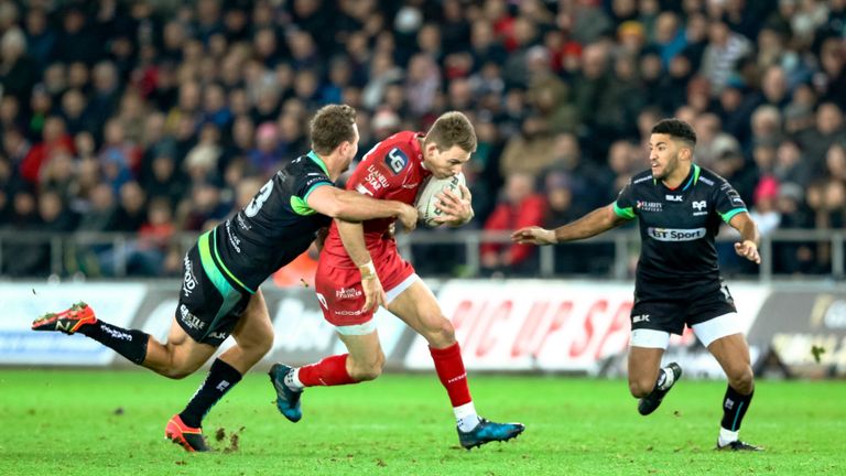 Scarlets' Liam Williams is tackled by Ospreys' Ashley Beck