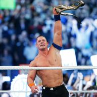 John Cena holds his 16th world title aloft