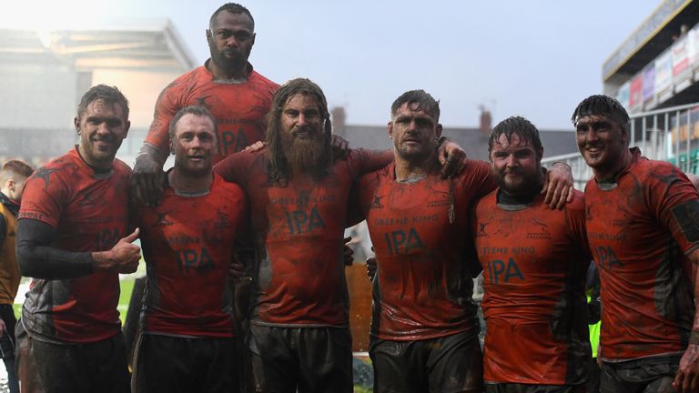 Falcons players celebrate their muddy victory