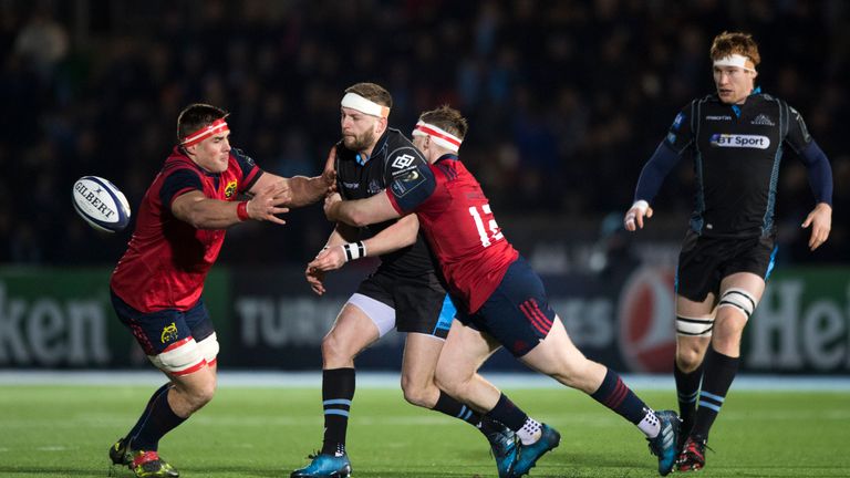 Finn Russell is tackled by Munster's CJ Stander (left) and Rory Scannell