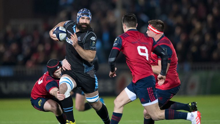 Josh Strauss is tackled by Munster's Tyler Bleyendaal (left)