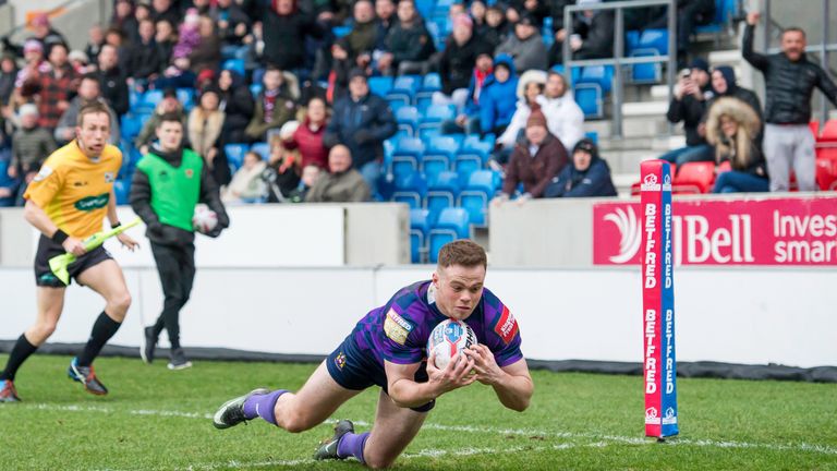 Wigan's Joe Burgess dives over for a try against Salford