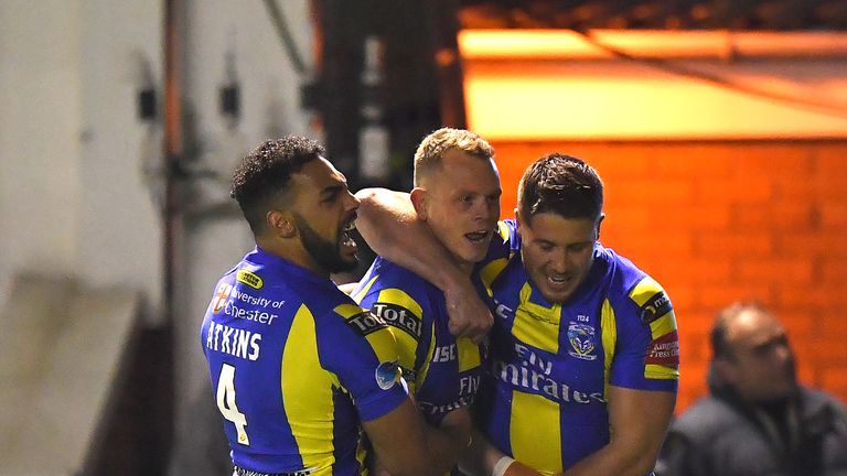 Warrington Wolves' Kevin Brown is congratulated on scoring his team's opening try 