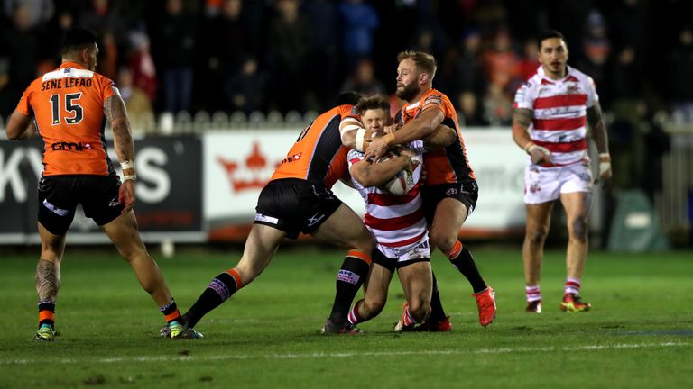 Leigh Centurions' Ben Crooks  is tackled by Castleford Tigers' Paul McShabe (right) and Grant Millington