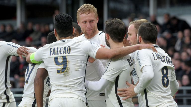 Kamil Glik is mobbed by his team-mates after scoring at Guingamp