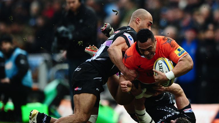 Sinoti Sinoti is tackled by Exeter's Ian Whitten (right) and Olly Woodburn