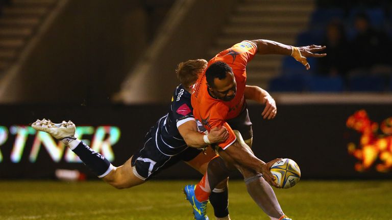 Vereniki Goneva of Newcastle Falcons beats a challenge from Mike Haley of Sale Sharks to score his third try