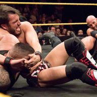 Johnny Gargano and Tommaso Ciampa try to submit The Authors of Pain