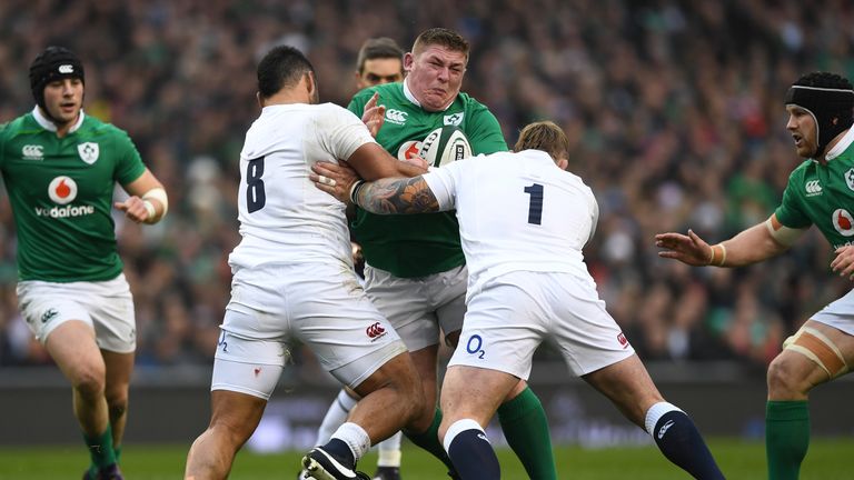 Tadhg Furlong of Ireland is tackled by Billy Vunipola and Joe Marler