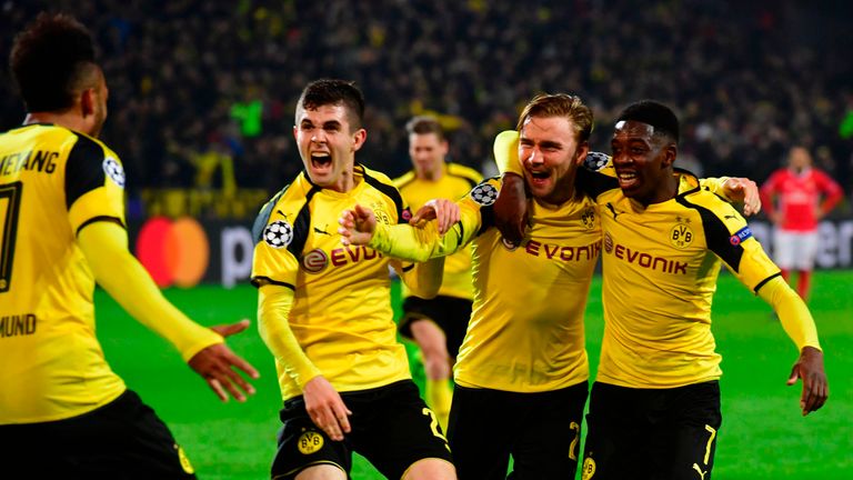 Aubameyang is congratulated by his Dortmund team-mates after scoring to make it 3-0